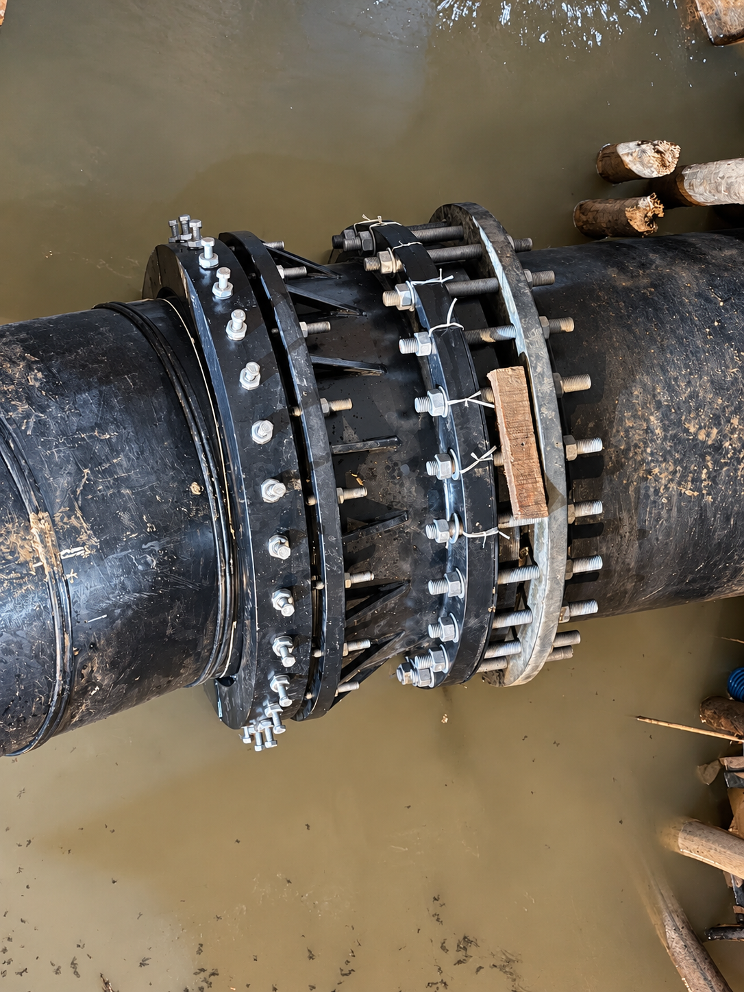 A closer view of the bolted joint and surrounding pipework.